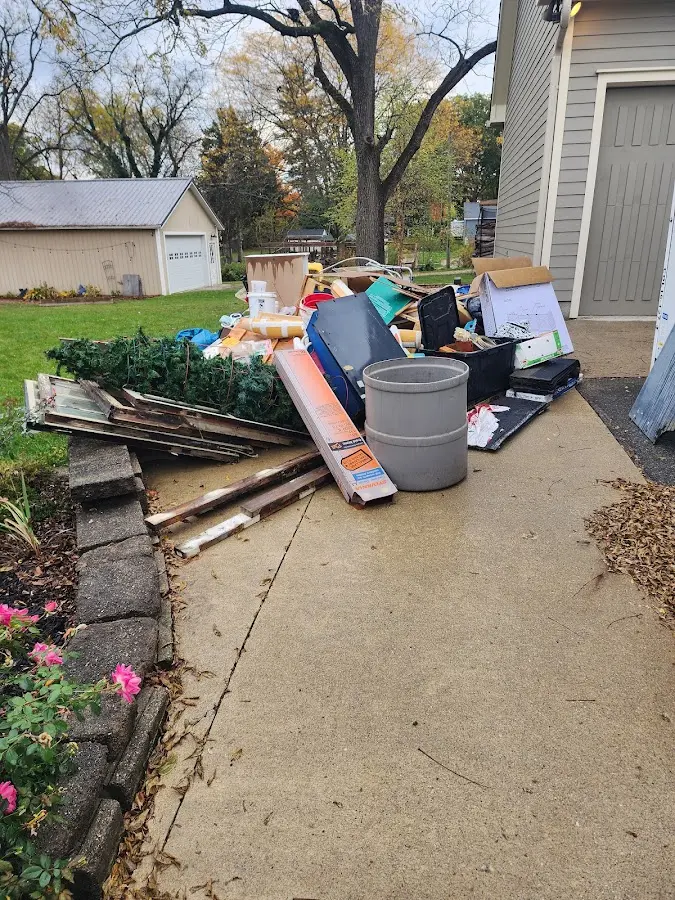 Dumpster being loaded with debris for Demolition Dumpster Rental in Brimfield